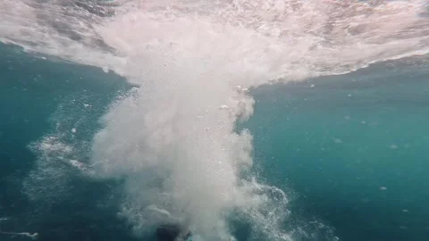 Close up of one young man jumping in to the water of the sea from a cliff or doc Stock Footage 249692850