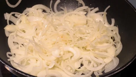 Close up of onions in a frying pan Stock Footage 78972647