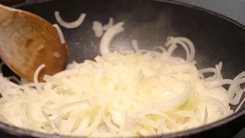 Close up of onions in a frying pan Stock Footage 78972985