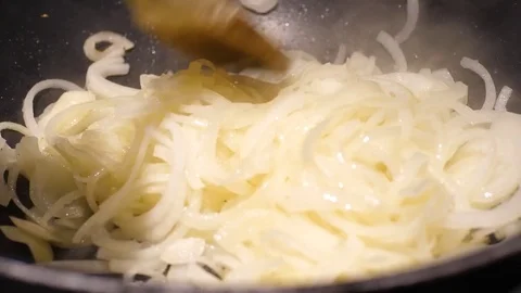 Close up of onions in a frying pan Stock Footage 78973354