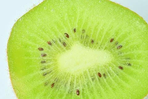 Close-op of kiwi  fruit with bubbles. Bright view photo. Kiwi fruit slice i.. Stock-Fotos