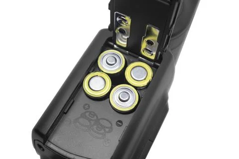 Close-up of an open battery compartment in a camera flash speedlight loaded.. Foto stock