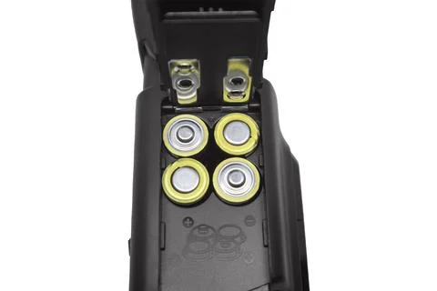 Close-up of an open battery compartment in a camera flash speedlight loaded.. Stock Photos