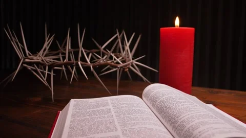 Close-up of open Bible, the crown of thorns and a red burning candle. Easter. Stock Footage 304106179