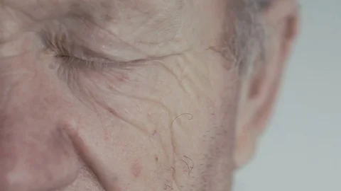 Close up of open blue eye of old man looking at camera on background 스톡 동영상 69755928