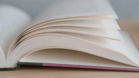 Close up of open book on the table Stock Footage 138703776