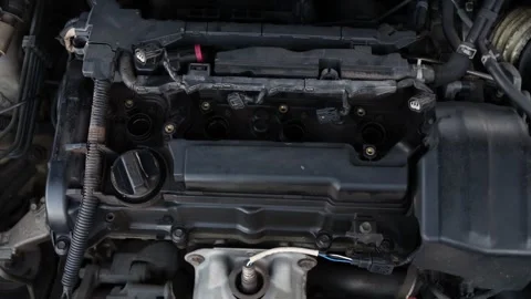Close-up of open car engine showing spark plug wells and components  Stock-Footage 346640889