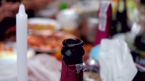 Close-up of an Open Champagne Bottle on a Messy Party Table After a Celebration Stock Footage 335137460