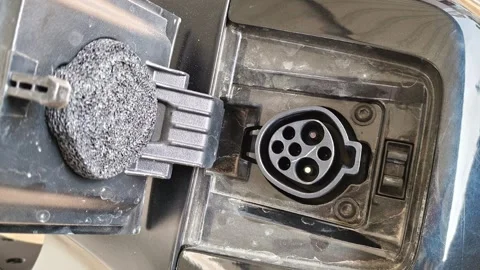 Close up of an open charging socket on a modern black electric scooter or e-bike Видео 328229905