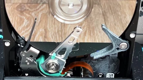 Close up of an open computer internal hard drive movement Stock Footage 283658044