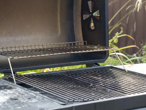 Close-up of open empty barbecue grill on the street. Food preparation device Stock Photos