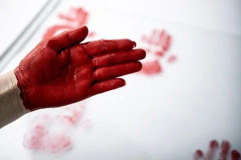 Close-up of an open hand covered in red paint with blurred. Stock Photos
