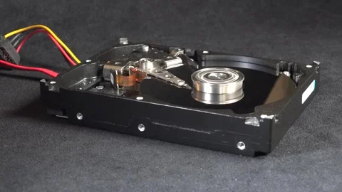 Close-up of an open hard drive with exposed internal components moving and s Stock Footage 293906622