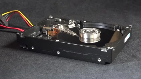 Close-up of an open hard drive with exposed internal components starting up 動画素材 293907960
