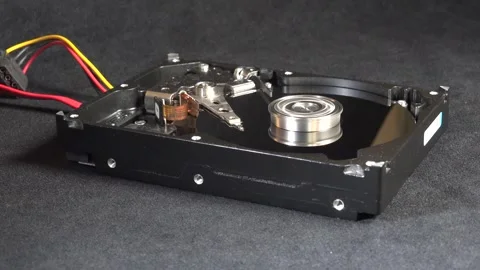 Close-up of an open hard drive with exposed internal components starting up, 動画素材 293908262