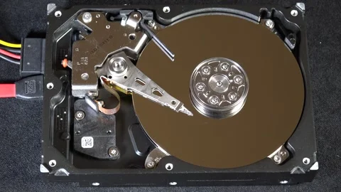 Close-up of an open hard drive with spinning platter and moving reading arm Stock Footage 293903864