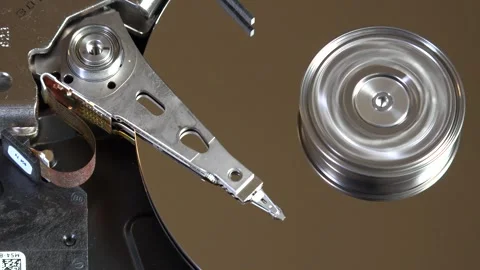 Close-up of an open hard drive with spinning platter and moving reading arm Stock Footage 293904212
