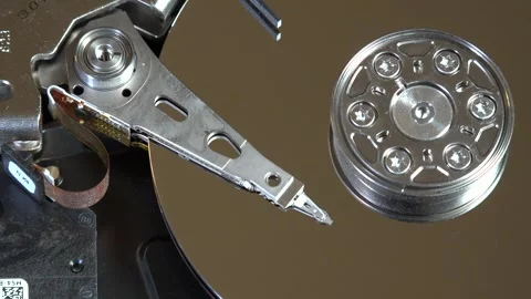 Close-up of an open hard drive with spinning platter and moving reading arm Stock Footage 293904426