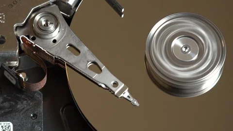Close-up of an open hard drive with spinning platter and moving reading arm Stock Footage 293904529
