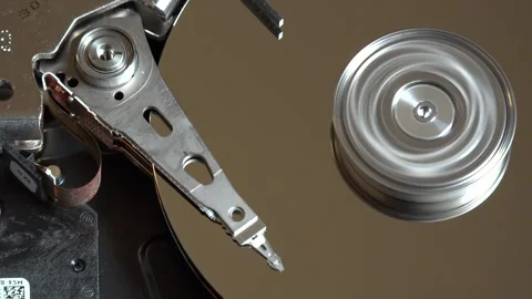 Close-up of an open hard drive with spinning platter and moving reading arm Stock Footage 293905308