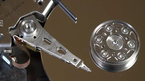 Close-up of an open hard drive with spinning platter and moving reading arm Stock Footage 293908561