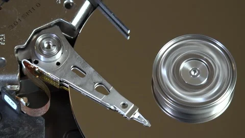 Close-up of an open hard drive with spinning platter and moving reading arm Stock Footage 293908673