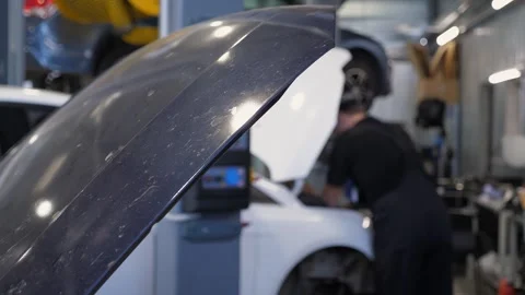 Close-up of the open hood of a car in a service station,a mechanic in the garage Stock Footage 337220983