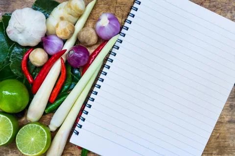 Close up. Open notebook with ingredients Thai food (tom yum) on wooden backgr Stock Photos