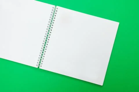 Close up of open notebook on spring lying on green background Stock Photos