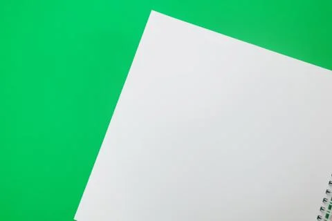 Close up of open notebook on spring lying on green background Stock Photos