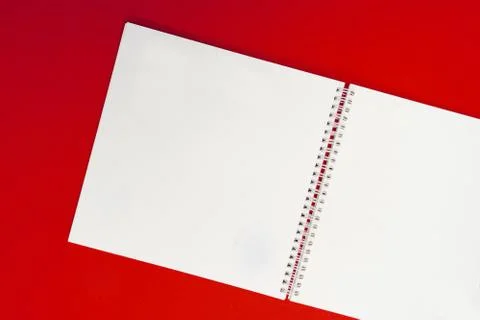 Close up of open notebook on spring lying on red background Stock Photos