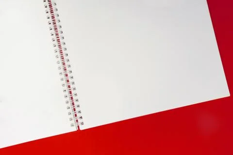 Close up of open notebook on spring lying on red background Stock Photos
