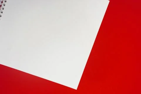 Close up of open notebook on spring lying on red background Stock Photos
