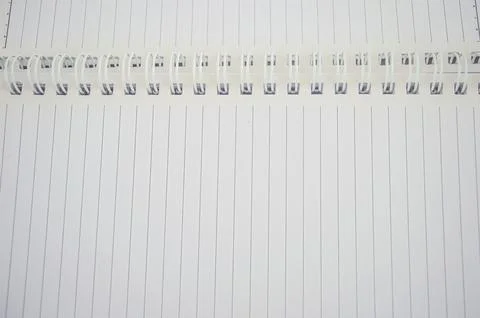 A close up of an open spiral notebook with lined pages. The image highlight.. Stock Photos