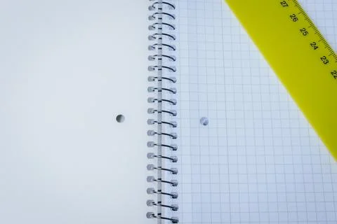 Close-up of an open spiral notebook with squared graph. Stock Photos