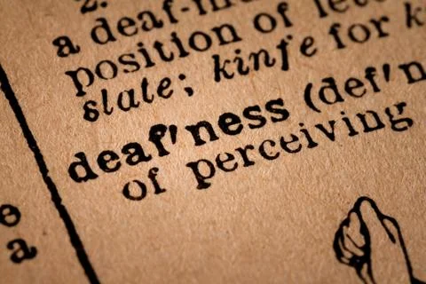 Close-up of an Opened Dictionary showing the Word Defness Stock Photos