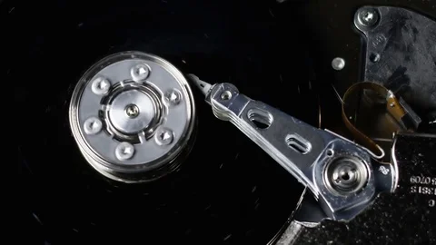 Close up of an opened hard drive disk spanning in slowmotion Stock Footage 73190779