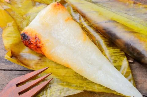 Close up opened thai dessert sticky rice wrapped in banana leaf Stock Photos