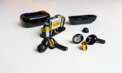 Close Up of Opened Wireless Earbud Showing Speaker Driver and Wires Stock Photos