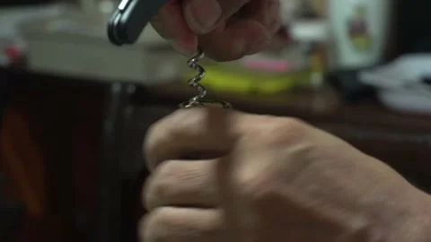 Close-up opening a bottle of wine with a corkscrew Stock Footage 146676164