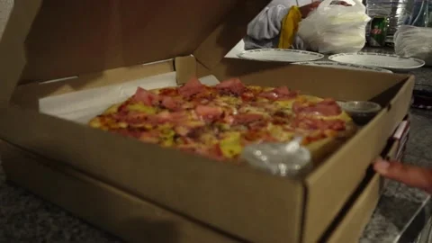 Close-up opening a cardboard box of pizza asking for delivery with the hands and Stock Footage 178477859