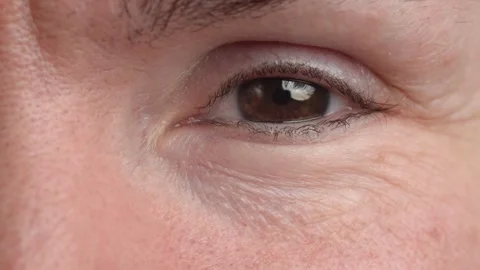 Close-up of opening eyes with brown iris Stock Footage 194565568