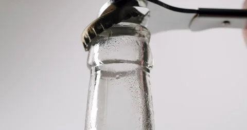 Close-up of opening a glass bottle with an opener Stock Footage 342735536