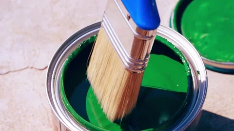 Close up opening green paint can bucket and mixing with brush. Garden renewal Stock Footage 217400631
