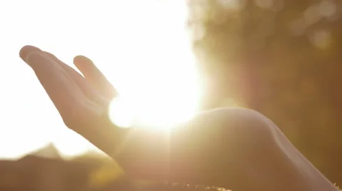 Close-up of opening the hand with the sun shining over the palm 스톡 동영상 67253633