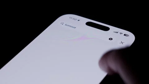 Close-up of opening the Komoot app in the Apple App Store on an iPhone. The Stock Footage 334062994