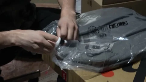 Close-up opening a Lenovo backpack just bought online with his hands Stock Footage 157994793