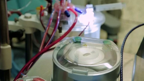 Close-up operating the heart-lung machine with tubes and flaps which runs the Stock Footage 74214247