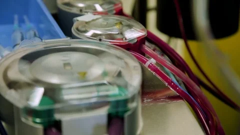 Close-up operating the heart-lung machine with tubes and flaps which runs the Stock Footage 74214765