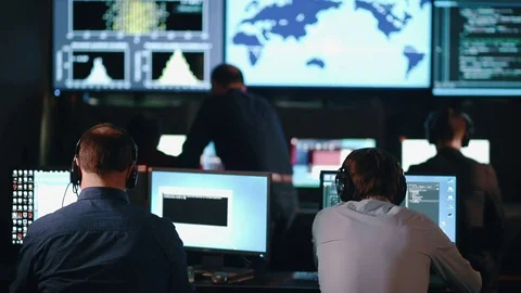 Close-up of Operations Engineer Working on His Computer With Multiple Displays Stock Footage 79844017